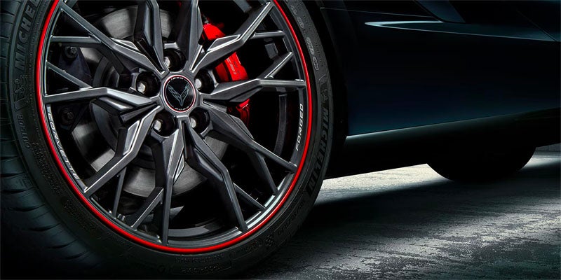 Close-up of a sports car wheel showcasing its sleek design.